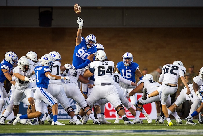 (Chris Detrick  |  The Salt Lake Tribune)  Brigham Young Cougars defensive lineman Corbin Kaufusi (90) blocks a field goal attempt by Utah State Aggies place kicker Dominik Eberle (62) during the game at Merlin Olsen Field at Maverik Stadium Friday, September 29, 2017.