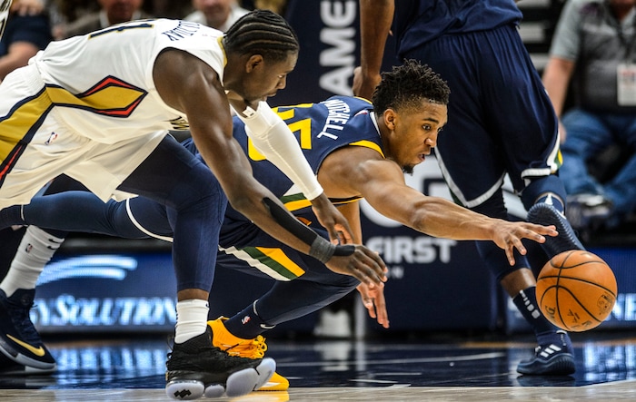 (Steve Griffin  |  The Salt Lake Tribune) Utah Jazz guard Donovan Mitchell (45), right, and New Orleans Pelicans guard Jrue Holiday (11) leap for the ball during the the Utah Jazz versus the New Orleans Pelicans NBA basketball game at the Vivint Smart Home Arena in Salt Lake City Wednesday January 3, 2018.