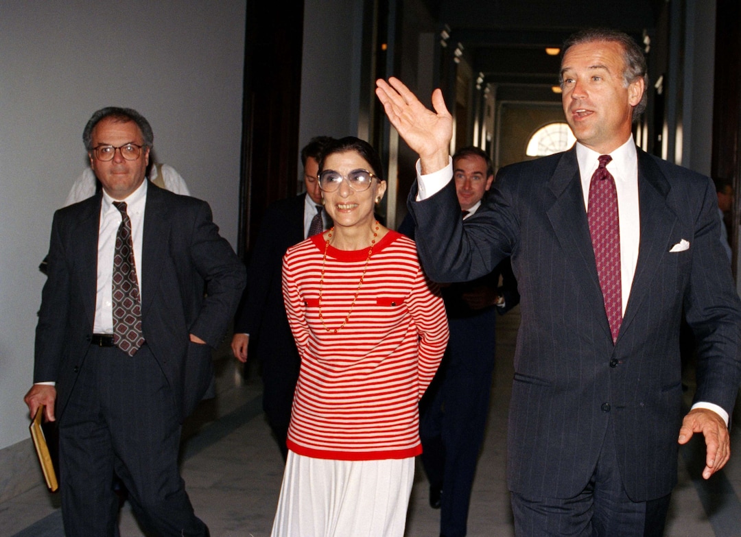 Sen. Joe Biden (D-Del.), chariman of the Senate Judiciary Committee, escorts Judge Ruth Bader Ginsburg, Pres. Clinton's choice for Supreme Court vacancy, on Capitol Hill, June 15, 1993. (AP Photo/Marcy Nighswander)