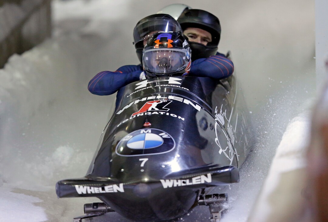 United States driver Steven Holcomb, foreground, with Frank Delduca, Carlo Valdes, and Samuel McGuffie, finishes a four-man bobsled World Cup race Saturday, Jan. 16, 2016, in Park City, Utah. (AP Photo/Rick Bowmer)