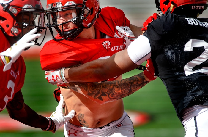 (Steve Griffin  |  The Salt Lake Tribune) Utah wide receiver Jameson Field battles to get free of the defense during the University of Utah football team's first scrimmage at Rice-Eccles Stadium in Salt Lake City Friday March 30, 2018.