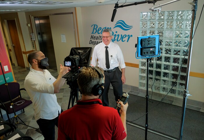 (Leah Hogsten | The Salt Lake Tribune)  Dr. Edward Redd, center, with the Bear River Health Department is filmed by two filmakers with Penna Powers ad agency, Bobby Brinton, left, and Jordan Whitney, right,  May 11, 2021 for public service announcements to encourage Utahns to get the COVID-19 vaccine.