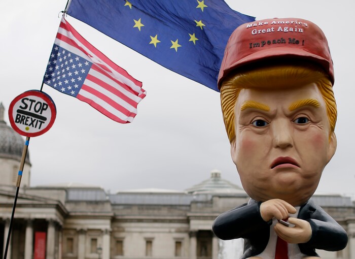 Large puppet portraying Donald Trump is carried as people gather in Trafalgar Square, central London, to demonstrate against the state visit of President Donald Trump, Tuesday, June 4, 2019. Trump will turn from pageantry to policy Tuesday as he joins British Prime Minister Theresa May for a day of talks likely to highlight fresh uncertainty in the allies' storied relationship. (AP Photo/Tim Ireland)