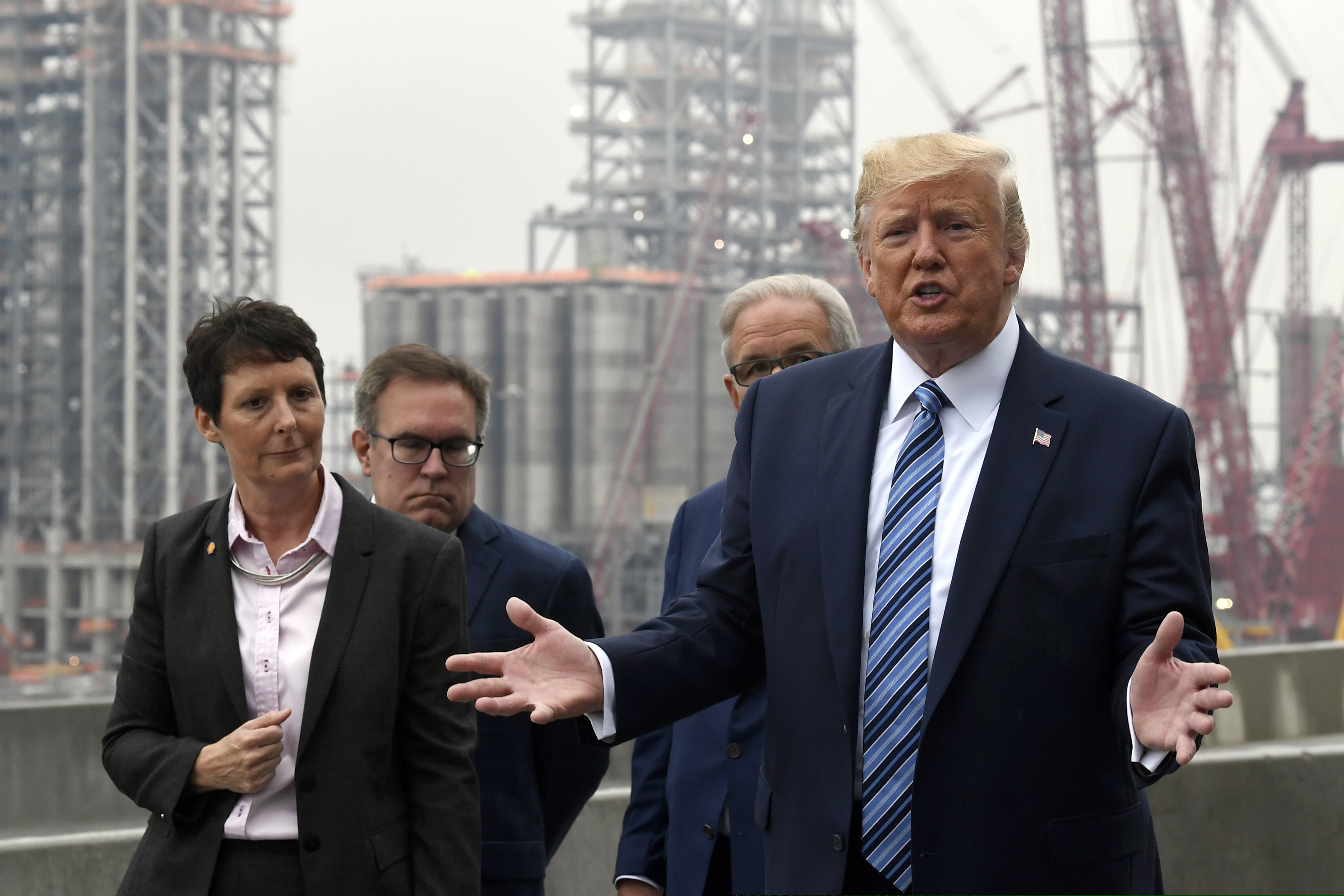 President Donald Trump speaks as he views construction during a visit to Shell's soon-to-be completed Pennsylvania Petrochemicals Complex on Tuesday, Aug. 13, 2019, in Monaca, Pa. At left is Hilary Mercer, vice president of Shell Pennsylvania Chemicals, left, and second from left is Environmental Protection Agency administrator Andrew Wheeler and Charles Holliday, chairman of the board of directors for Royal Dutch Shell. (AP Photo/Susan Walsh)