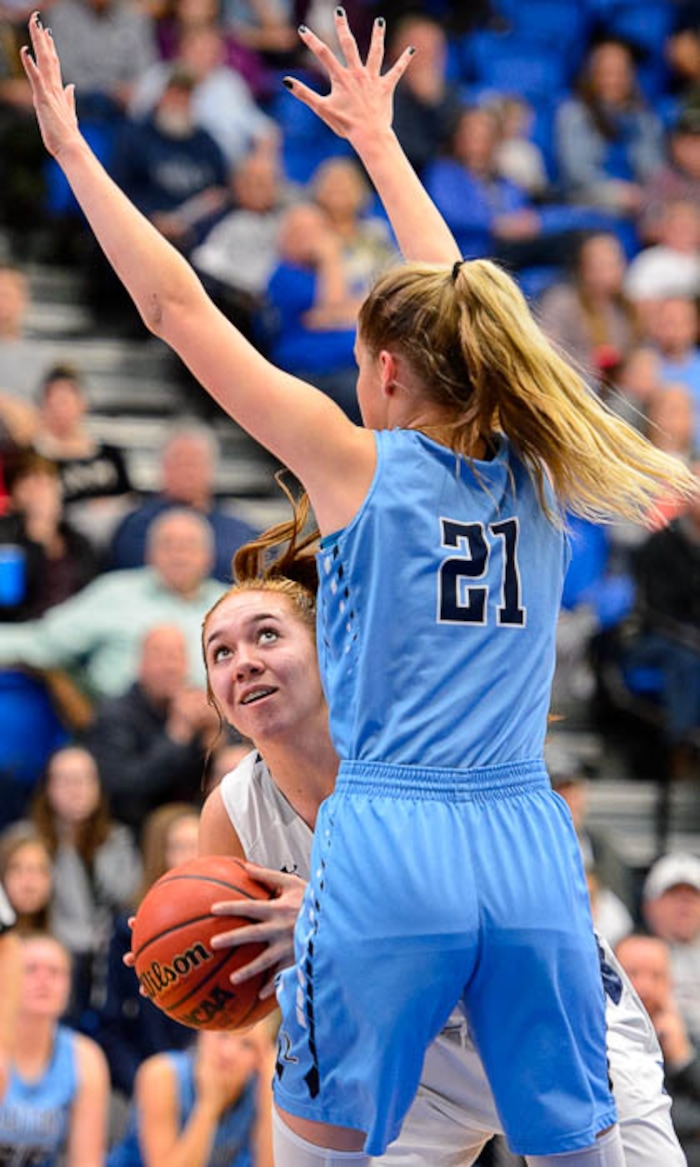 (Trent Nelson | The Salt Lake Tribune)  Copper Hills's Taela Laufiso (12) defended by Layton's Gracey Criswell (21)  as Layton faces Copper Hills in the 6A High School Girls' Basketball Tournament at SLCC in Taylorsville, Thursday Feb. 22, 2018.