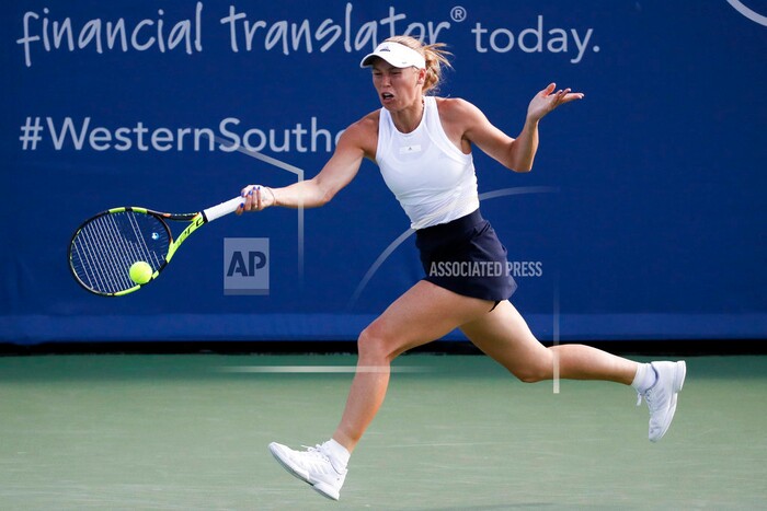 Caroline Wozniacki, of Denmark, returns to Karolina Pliskova, of the Czech Republic, at the Western & Southern Open tennis tournament, Friday, Aug. 18, 2017, in Mason, Ohio. (AP Photo/John Minchillo)