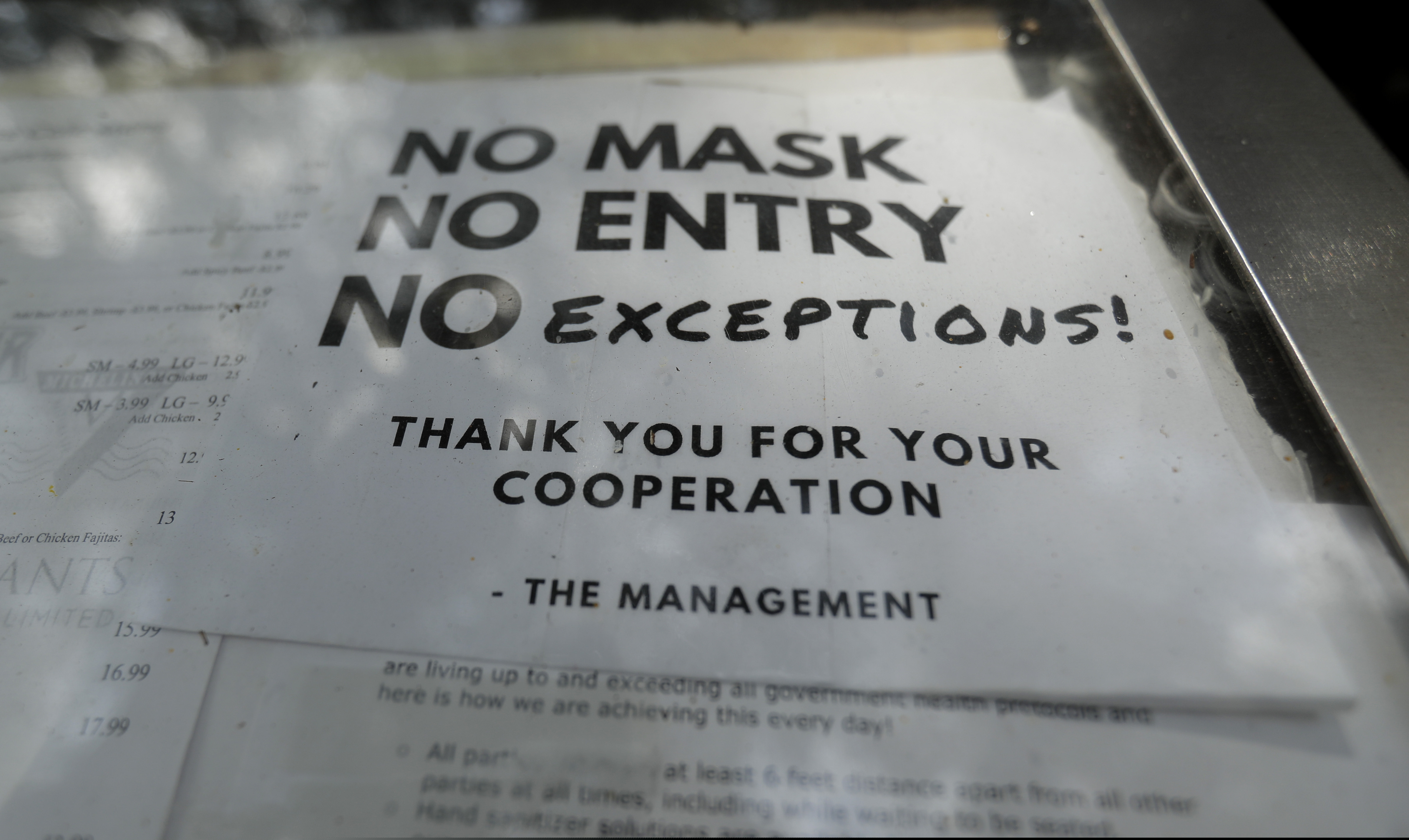 (Eric Gay | AP file photo)  A sign requiring face masks to protect against the spread of COVID-19 is seen at a restaurant, Tuesday, July 7, 2020, in San Antonio.
