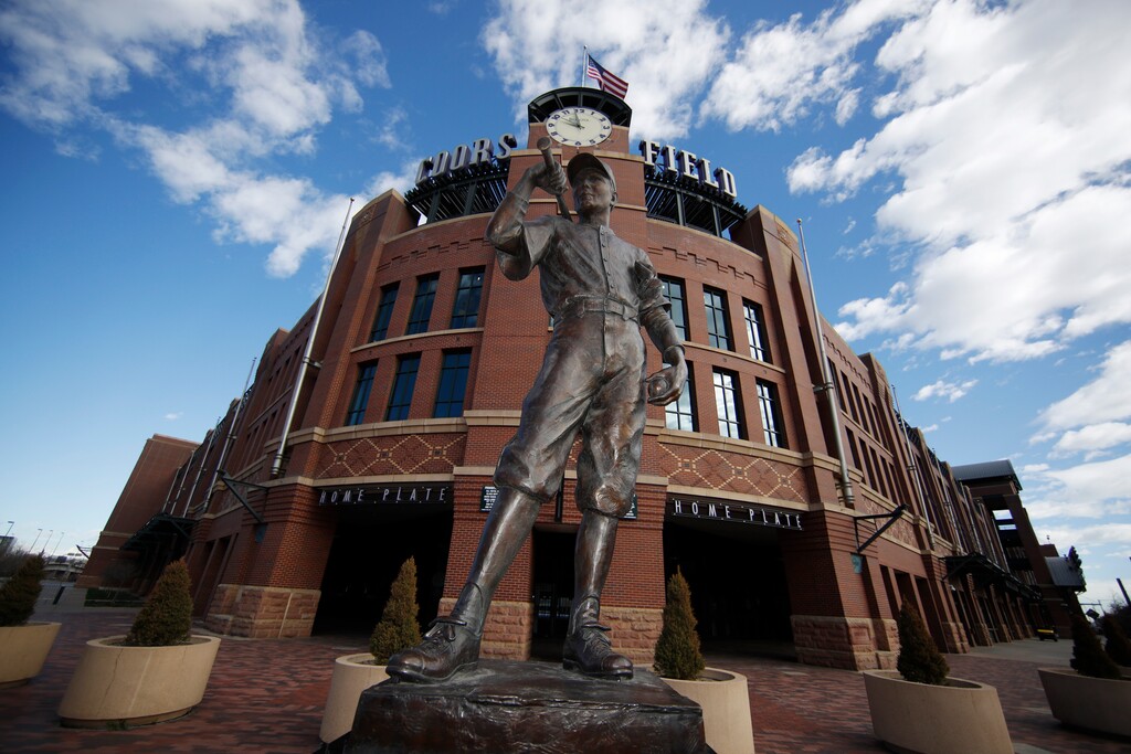 The sculpture named "The Player" stands alone in front of Coors Field, home to Major League Baseball's Colorado Rockies, as individuals stay in place to reduce the spread of the new coronavirus, March 23, 2020, in Denver. Major League Baseball and the players agreed to a 60-game season on Tuesday. (AP Photo/David Zalubowski)