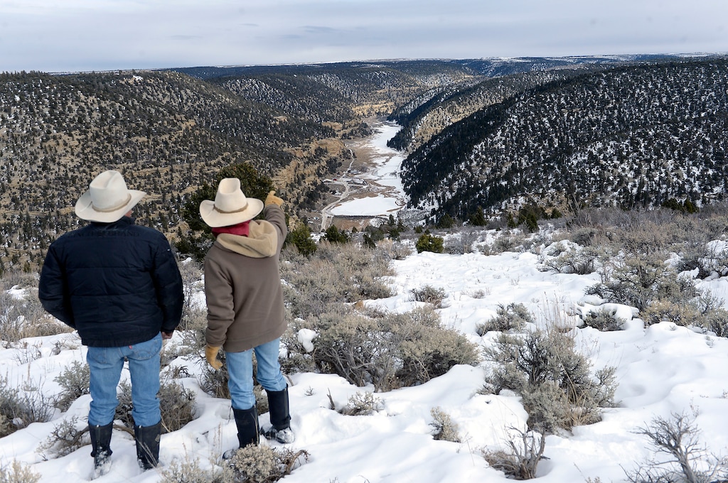 (Al Hartmann | Tribune file photo)
Bert and Christine DeLambert look down onto their cattle ranch along the long valley in Main Canyon in Uintah County Thursday Dec. 8, 2016. The DeLamberts' land is immediately below the PR Spring tar sands mine on the rim about three miles away. His springs have gone dry in the years since U.S. Oil Sands drilled exploratory holes and water wells.
The DeLamberts unsuccessfully tried to block a water rights transfer to U.S. Oil Sands that would allow them to pump more groundwater.