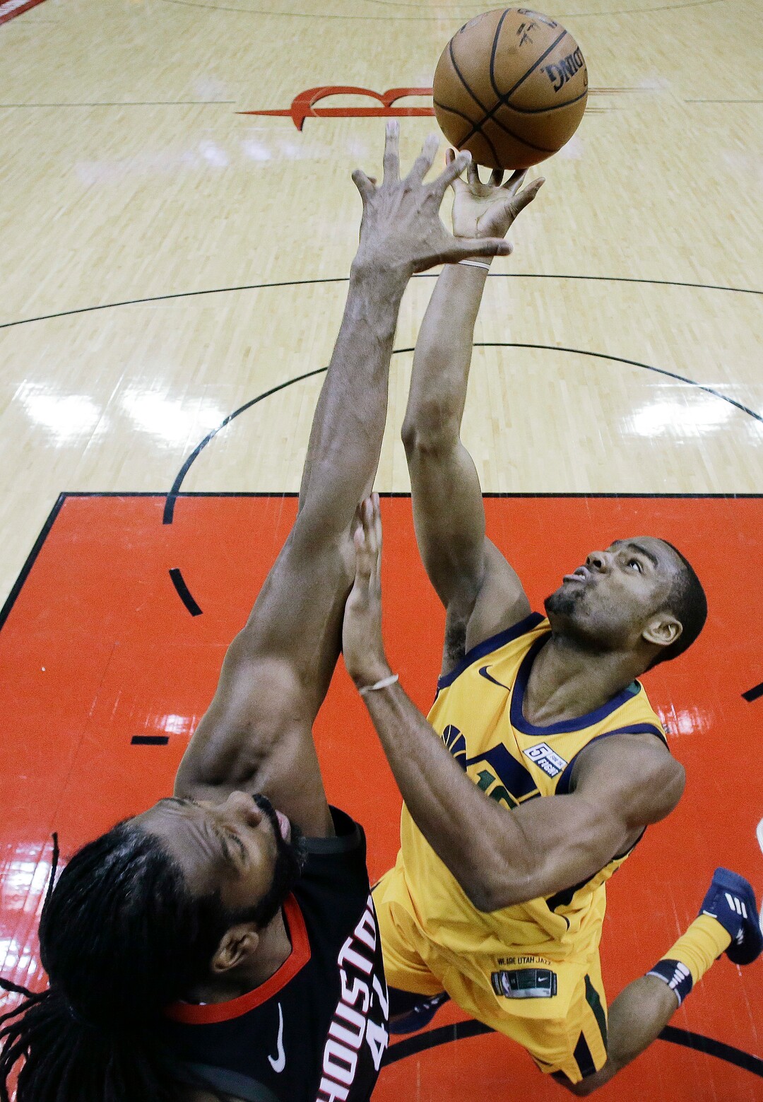 Houston Rockets center Nene Hilario, left, blocks the shot of Utah Jazz guard Alec Burks during the first half in Game 1 of an NBA basketball second-round playoff series, Sunday, April 29, 2018, in Houston. (AP Photo/Eric Christian Smith)