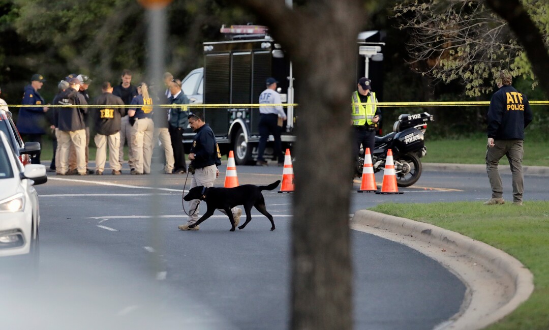 Officials work and stage near the site of Sunday's deadly explosion, Monday, March 19, 2018, in Austin, Texas. Police warned nearby residents to remain indoors overnight as investigators looked for possible links to other package bombings elsewhere in the city this month. (AP Photo/Eric Gay)
