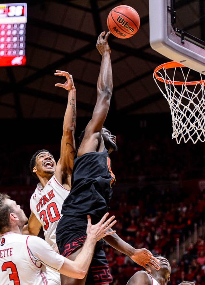 (Trent Nelson | The Salt Lake Tribune)  USC Trojans forward Chimezie Metu (4) scores, with Utah Utes guard Gabe Bealer (30) behind as the University of Utah hosts USC, NCAA basketball at the Huntsman Center in Salt Lake City, Saturday Feb. 24, 2018.