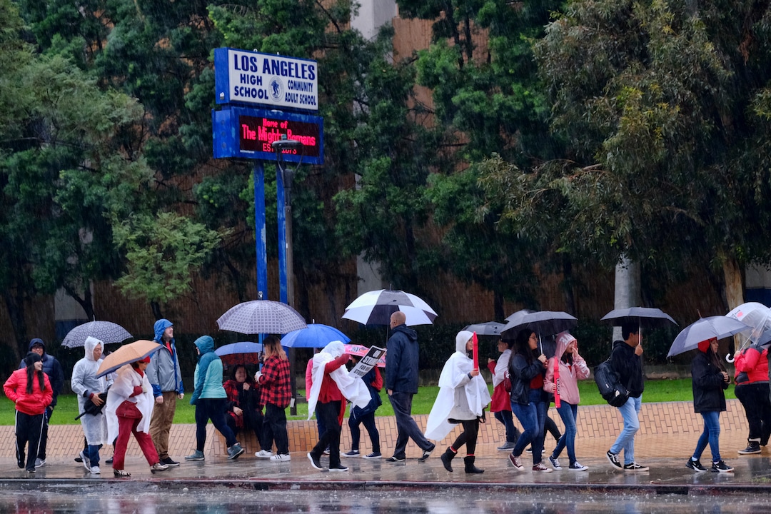(Richard Vogel | The Associated Press)  Los Angeles Unified District teachers joined by students brave the pouring rain to join in a picket line during a citywide teacher strike in front of Los Angeles High School on Monday, Jan. 14, 2019. Tens of thousands of Los Angeles teachers went on strike Monday after contentious contract negotiations failed in the nation's second-largest school district.