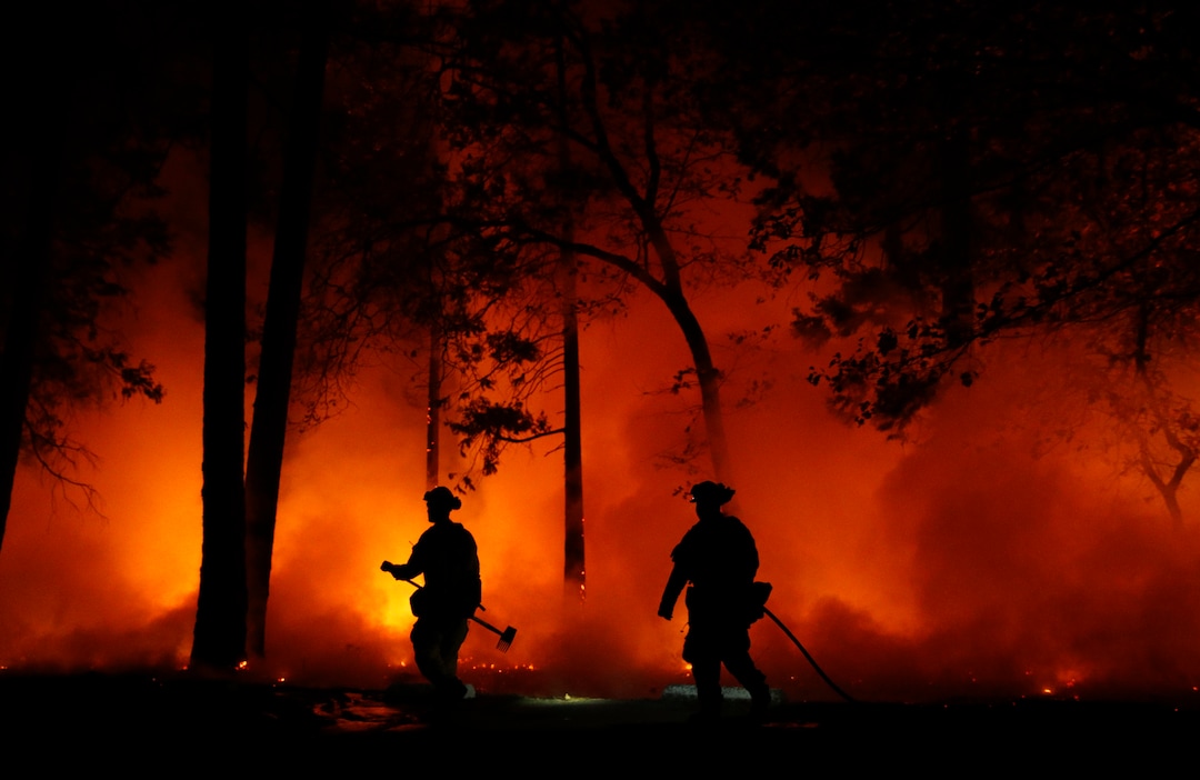 Firefighters work on a controlled burn at a wildfire, Friday, Nov. 9, 2018, in Magalia, Calif. (AP Photo/John Locher)