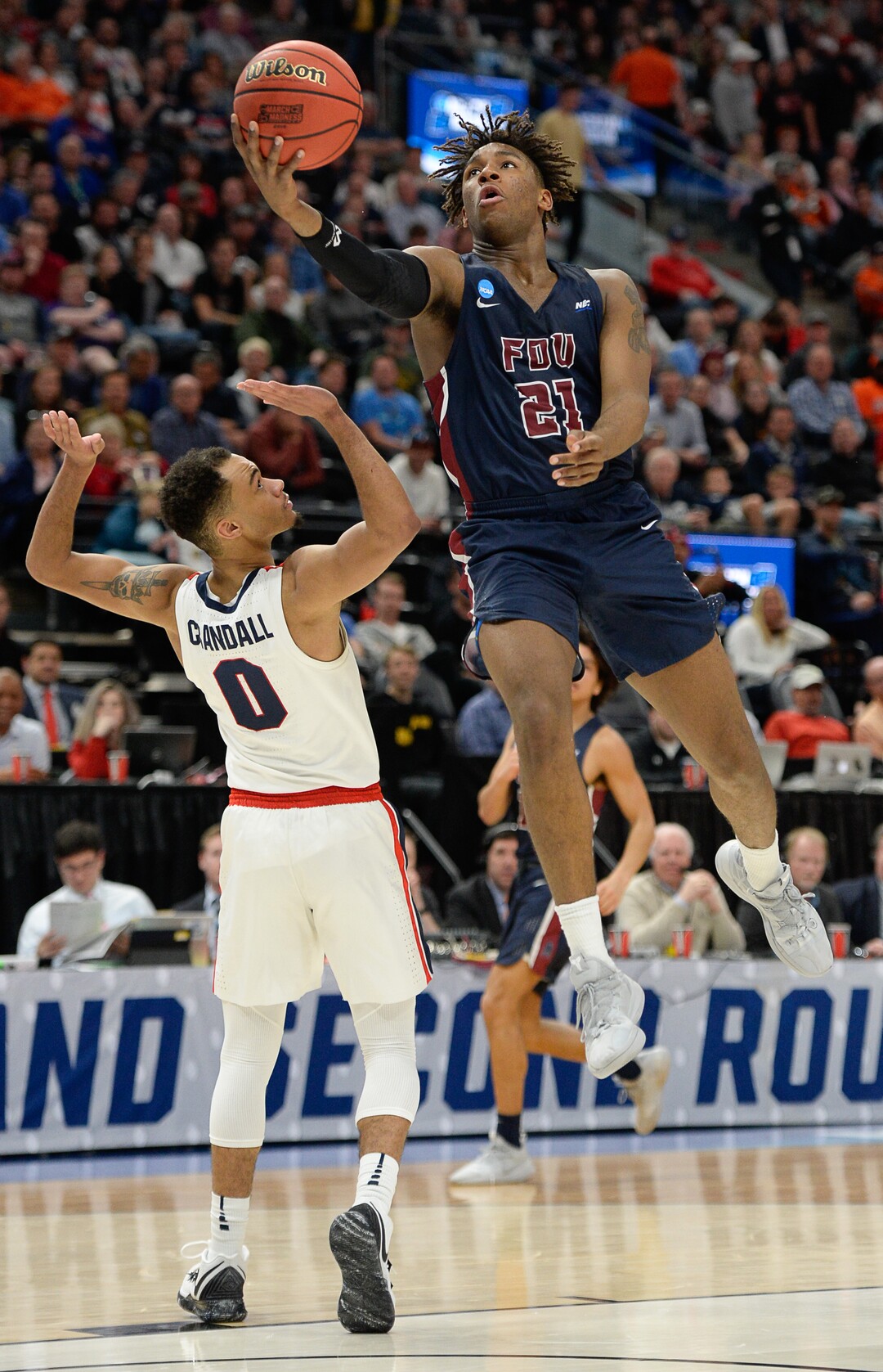 (Francisco Kjolseth  |  The Salt Lake Tribune)  Fairleigh Dickinson Knights forward Elyjah Williams (21) goes up for a shot over Gonzaga Bulldogs guard Geno Crandall (0) as Gonzaga faces Fairleigh Dickinson in their first round menÕs NCAA March Madness tournament game at Vivint Smart Home Arena in Salt Lake City on Thursday, March 21, 2019.