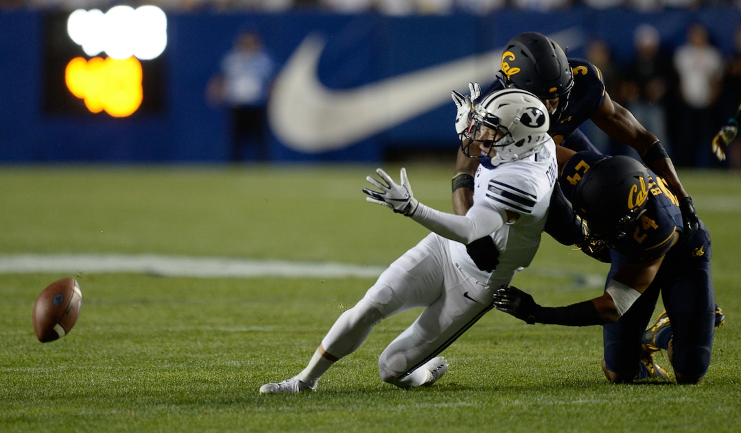 (Francisco Kjolseth  |  The Salt Lake Tribune)  Brigham Young Cougars wide receiver Dylan Collie (3) is taken down by California Golden Bears cornerback Camryn Bynum (24) and California Golden Bears quarterback Ross Bowers (3) barrels in during the first half of the NCAA college football game, Saturday, Sept. 8, 2018, at LaVell Edwards stadium in Provo, Utah.