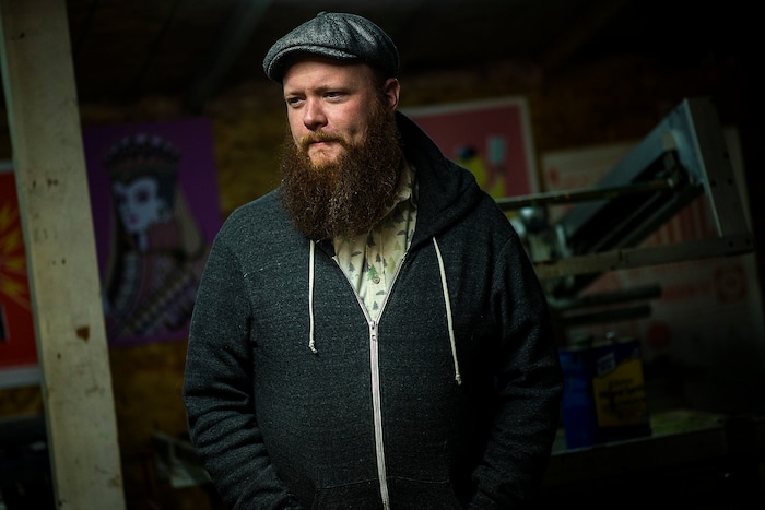 (Chris Detrick | The Salt Lake Tribune) Artist Travis Bone poses for a portrait in his workshop in Midvale Tuesday, November 28, 2017.