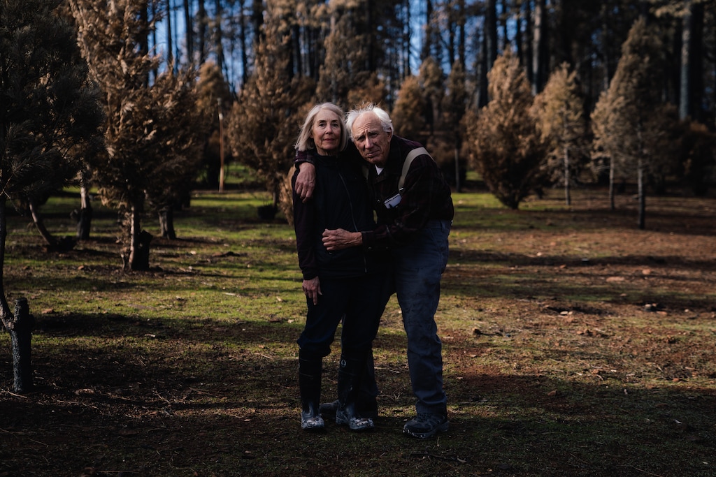 Anne Benoit and Joe McNally stand on what remains of their Christmas tree farm in Paradise, Calif. on Dec. 7, 2018. MUST CREDIT: Photo for The Washington Post by Mason Trinca