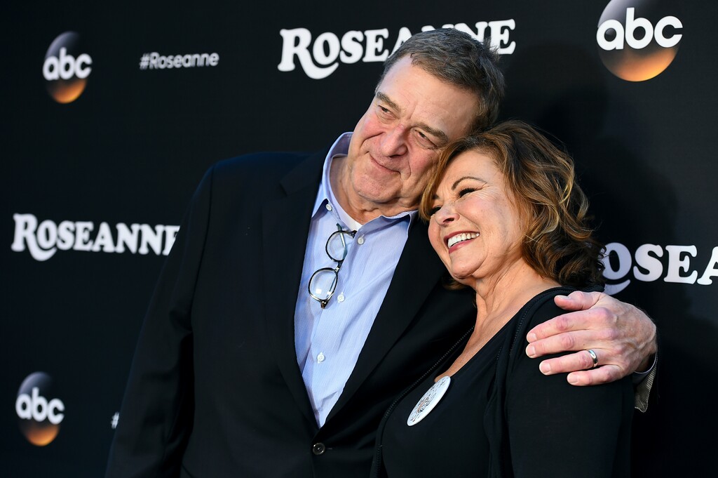 FILE - In this March 23, 2018 file photo, John Goodman, left, and Roseanne Barr arrive at the Los Angeles premiere of "Roseanne"  in Burbank, Calif.   ABC has cancelled its hit reboot of “Roseanne” following her racially insensitive tweet about former Obama adviser Valerie Jarrett, Tuesday, May 29.  ABC Entertainment President Channing Dungey said the comment “is abhorrent, repugnant and inconsisten with our values, and we have decided to cancel the show.”  (Photo by Jordan Strauss/Invision/AP, File)