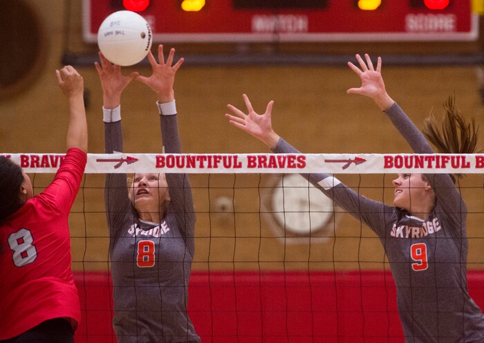 (Rick Egan  |  The Salt Lake Tribune)  Kaybrie Pe'a (8) hits the ball for Bountiful, as Kaitlyn Standifird (8) and Emilee Rupp(9) defend for Skyridge, in volleyball action, Bountiful vs. Skyridge, at Bountiful High, Wednesday, September 6, 2017.