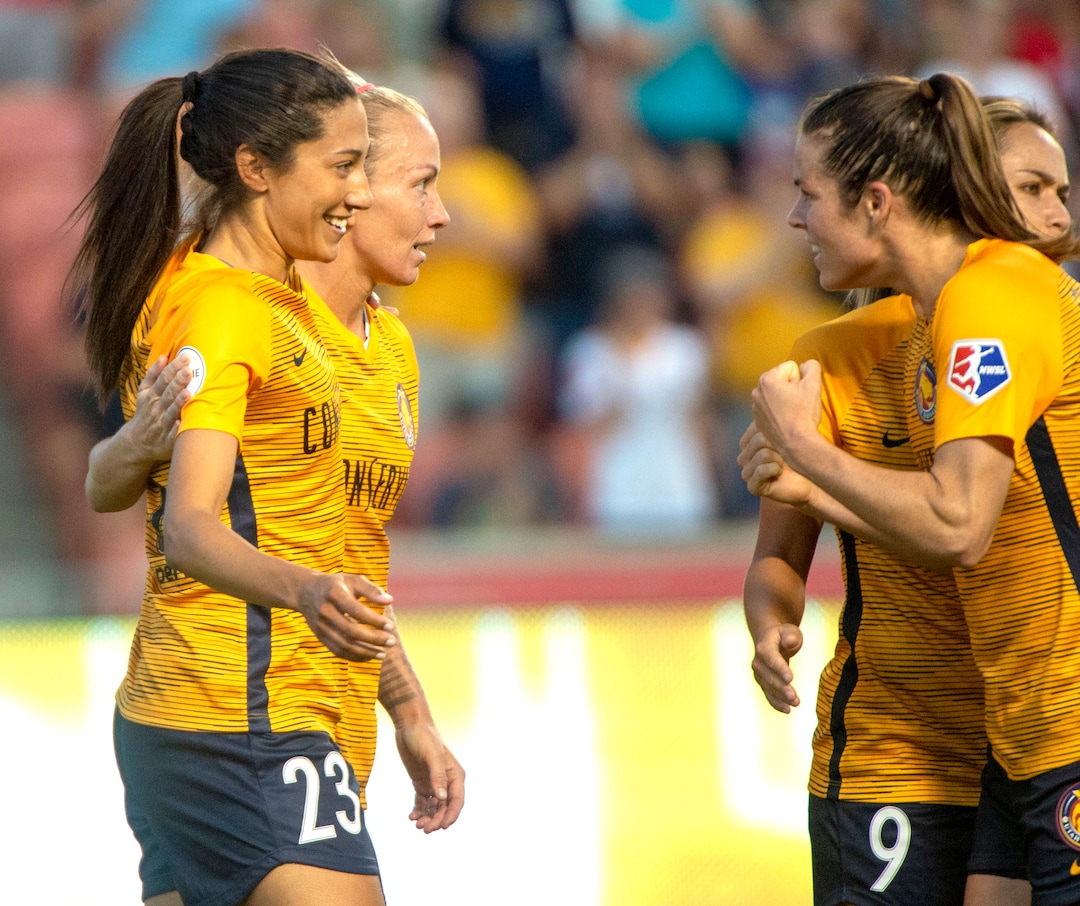 (Rick Egan  |  The Salt Lake Tribune)    Team mates celebrate with Utah forward Christen Press (23) after she scored a goal for The Royals, in Soccer action between Utah Royals FC and Portland Thorns FC, in Sandy, Friday, July 19, 2019.