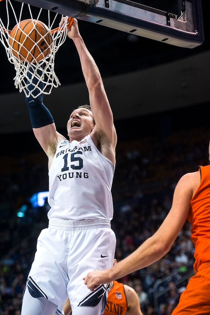 (Chris Detrick  |  The Salt Lake Tribune)  Brigham Young Cougars forward Payton Dastrup (15) dunks the ball during the game at the Marriott Center Thursday, December 21, 2017.  
