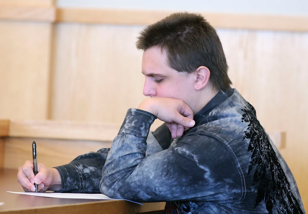 (Eli Lucero  |  Pool Photo)  Kalin Menlove-McGinni writes a note for his lawyer during his preliminary hearing for felony manslaughter, in 1st District Court in Logan on Tuesday October 20, 2015.