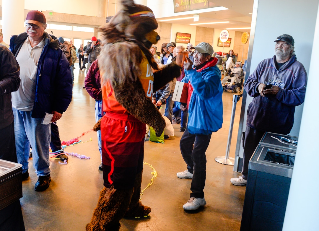 Leah Hogsten  |  The Salt Lake Tribune  Valentin Guzman shares a laugh with Jazz Bear at the Utah Jazz and the Larry H. Miller Group sponsored annual “We Care – We Share” Thanksgiving Meal for local homeless and low-income families, Monday, Nov 19, 2018.