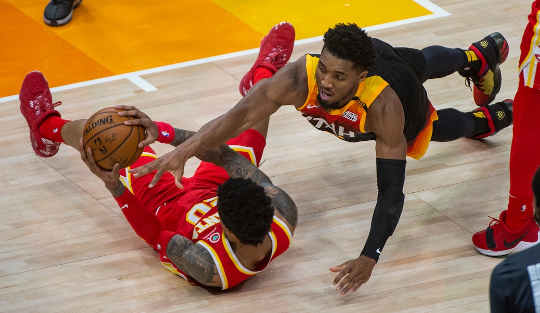 (Rick Egan | The Salt Lake Tribune) Utah Jazz guard Donovan Mitchell (45) dives for a loose ball, along with Atlanta Hawks forward John Collins (20), in NBA action between the Utah Jazz and the Atlanta Hawks at Vivint Arena, on Friday, Jan. 15, 2021.