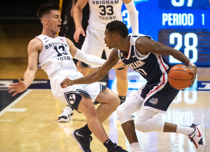 (Rick Egan | The Salt Lake Tribune)  Brigham Young Cougars guard Alex Barcello (13) is called for a personal foul, as he collides with Gonzaga Bulldogs guard Joel Ayayi (11), in West Coast Conference Basketball action between the Brigham Young Cougars and the Gonzaga Bulldogs at the Marriott Center in Provo, on Monday, Feb. 8, 2021.