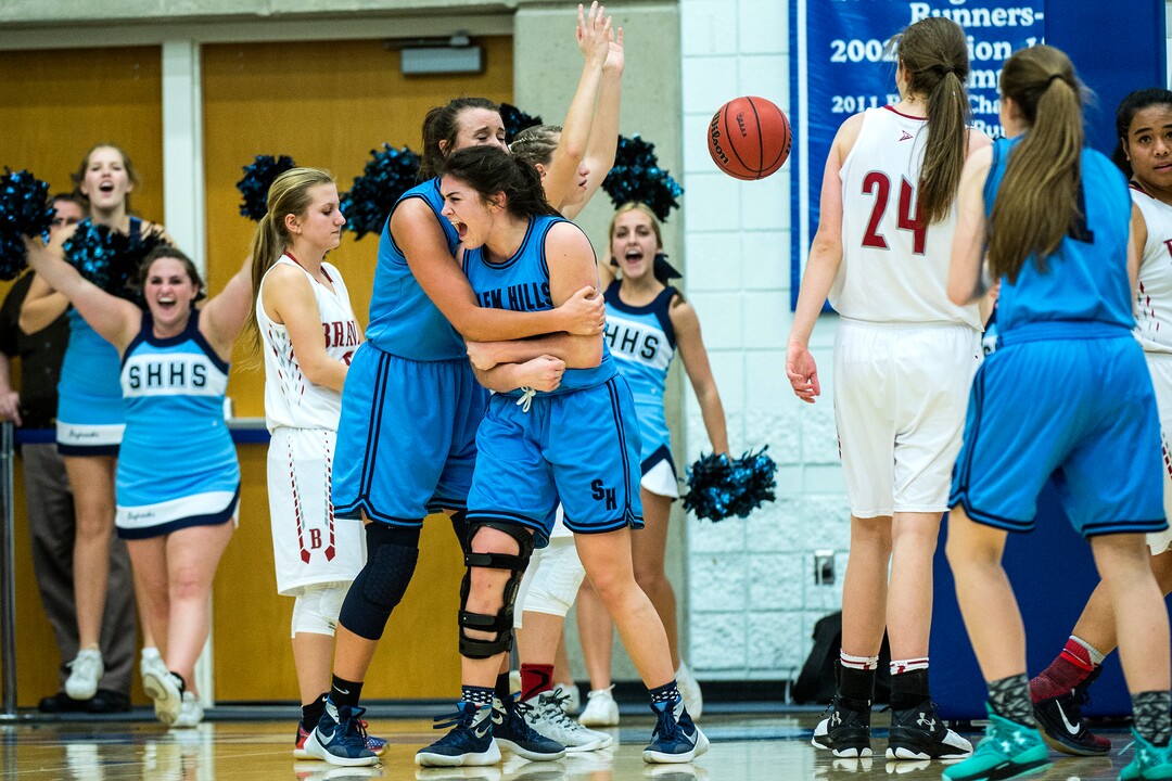 Chris Detrick  |  The Salt Lake TribuneSalem Hills's Lauren Gustin (12) and Salem Hills's JaneAshley Nelson (24) celebrate a point during the 4A girls' basketball semifinals at Salt Lake Community College Friday February 26, 2016. Bountiful won the game 59-51.