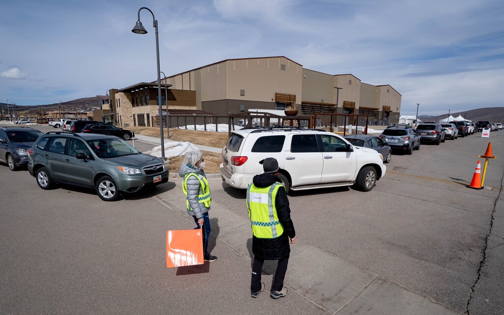 (Francisco Kjolseth  | The Salt Lake Tribune) People line up for their COVID-19 vaccine on Thursday, March 18, 2021, as the Utah Film Studios in Park City loans its space to the Summit County Health Department as a drive-thru COVID-19 vaccination station.