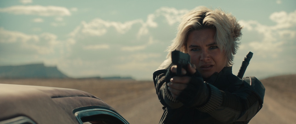 (Marvel Studios) Florence Pugh, portraying black ops expert Yelena Belova, aims a pistol during a car chase sequence filmed near Green River, Utah, for the Marvel Studios movie "Thunderbolts*."
