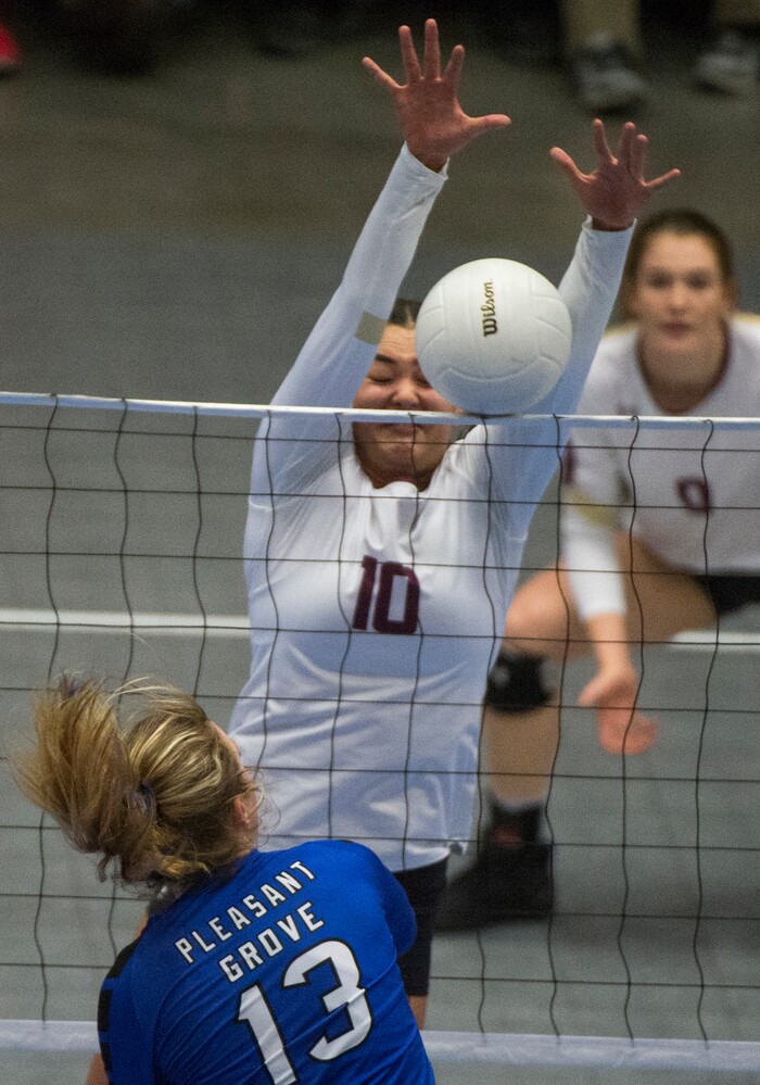 (Rick Egan  |  The Salt Lake Tribune)  Pleasant Grove Vikings Savannah Scott (13) hits the ball, as Lone Peak Knights  Kennedi Boyd (10) defends, in championship volleyball action, Pleasant Grove vs. Lone Peak, at Utah Valley University, Saturday, November 4, 2017.