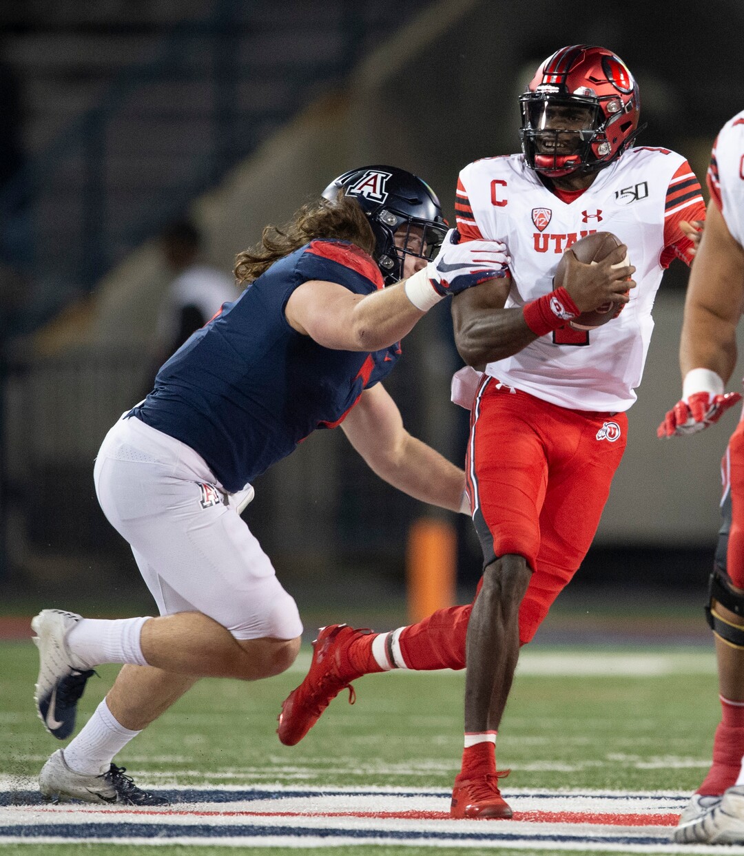 (Rick Egan  |  The Salt Lake Tribune)     Arizona Wildcats linebacker Colin Schooler (7) grabs Utah Utes quarterback Tyler Huntley (1) as he scrambles with the ball, in PAC-12 action between the Utah Utes and the Arizona Wildcats in Tucson, Saturday, Nov. 23, 2019.