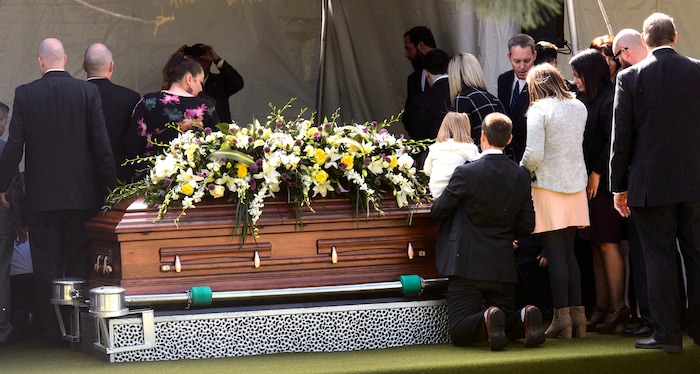 (Steve Griffin  |  The Salt Lake Tribune)  People gather around the casket following graveside services for Elder Robert D Hales at the Bountiful City Cemetery in Bountiful Friday October 6, 2017.