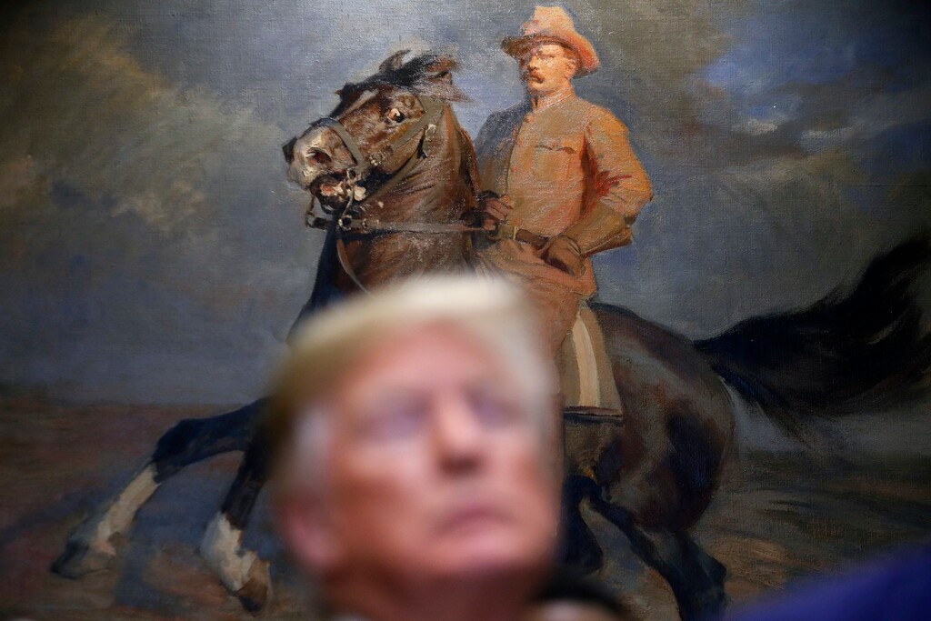 FILE - In this Dec. 12, 2018 file photo, U.S. President Donald Trump stands in front of a painting of former U.S. President Theodore Roosevelt in the Roosevelt Room of the White House, in Washington. (AP Photo/Jacquelyn Martin, File)