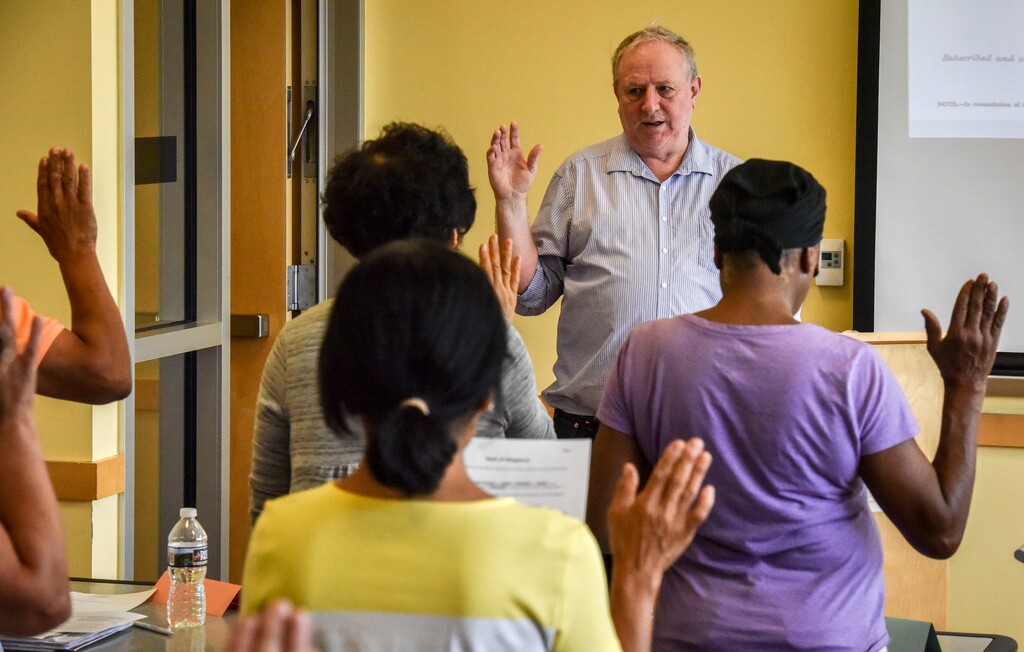 (Bill O'Leary | The Washington Post) Instructor Daniel McCall simulates the swearing in process for immigrants seeking citizenship during classes to help them with the process on August, 11, 2018 in Gaithersburg, Md.