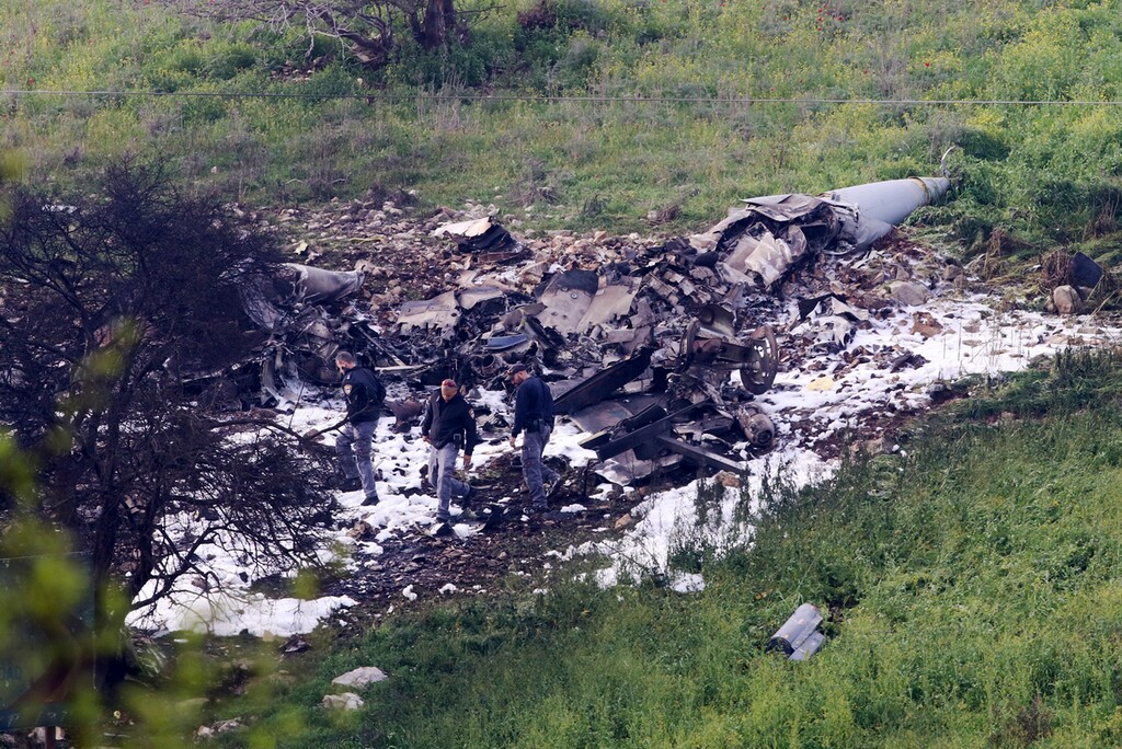 (Rami Slush | The Associated Press) Israeli security stands around the wreckage of an F-16 that crashed in northern Israel, near kibbutz of Harduf, Saturday, Feb. 10, 2018. The Israeli military shot down an Iranian drone it said infiltrated the country early Saturday before launching a "large-scale attack" on at least a dozen Iranian and Syrian targets inside Syria, in its most significant engagement since the fighting in neighboring Syria began in 2011. Responding anti-aircraft fire led to the downing of an Israeli fighter plane.