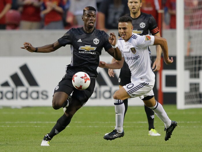 Manchester United midfielder Paul Pogba, left, controls the ball as Real Salt Lake midfielder Luis Silva (20) defends during the first half of a friendly soccer match Monday, July 17, 2017, in Sandy, Utah. (AP Photo/Rick Bowmer)