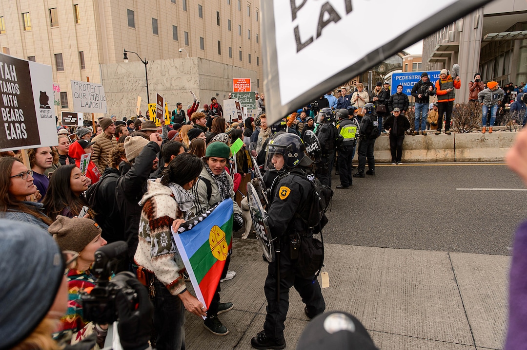 (Trent Nelson | The Salt Lake Tribune)  Protesters square off with a line of police after a rally against a visit by President Donald Trump, Monday December 4, 2017.