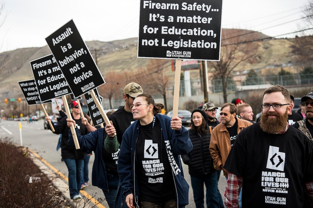 (Chris Detrick | The Salt Lake Tribune)  Participants hold signs during the March Before Our Lives rally near West High School in Salt Lake City Saturday, March 24, 2018.