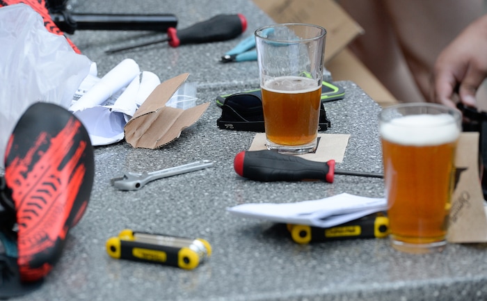 (Francisco Kjolseth  |  The Salt Lake Tribune)  Volunteers and workers at Squatter's Pub Brewery assemble 80 bicycles for kids on Tuesday, May 29, 2018. The bikes will be given away to 1st and 2nd graders at Washington Elementary on Wednesday as part of a program backed by the Can'd Aid Foundation.