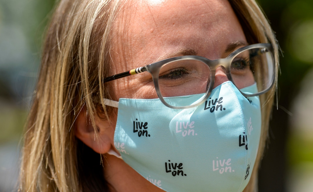 (Leah Hogsten  |  The Salt Lake Tribune) Kim Myers assistant director of Utah Division of Substance Abuse and Mental Health shows off her Live On mask to promote a 3-year campaign to bump up education, provide resources, and change the culture around suicide and mental health Thursday. The statewide campaign, Live On, is a statewide effort to help Utahns struggling with isolation, job loss and increased stress and anxiety surrounding COVID-19.