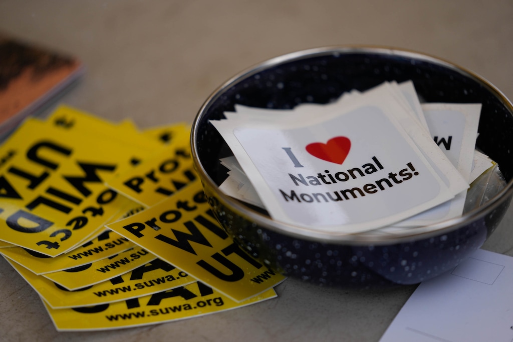 (Francisco Kjolseth  | The Salt Lake Tribune) Stickers are distributed as people gather on the steps of the Utah Capitol during a rally, organized by Southern Utah Wilderness Alliance, in support of protecting public lands on Saturday, Jan. 11, 2025.  Recent polling shows that the majority of Utah voters support national monuments in the state.