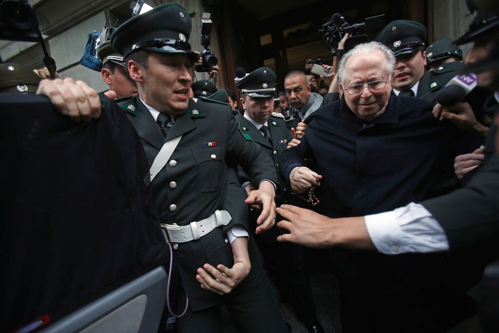 (AP Photo/Luis Hidalgo, File) In this Nov. 11, 2015 file photo, Rev. Fernando Karadima, center, is escorted from court after testifying in a lawsuit brought by three of his victims alleging sex abuse cover-up by the archdiocese of Santiago. One of Karadima's victims, Juan Carlos Cruz, will testify on Feb. 17, 2018 before a Vatican investigator in a separate, spinoff case that has raised questions about Pope Francis' already shaky track record on combatting sex abuse and cover-up.