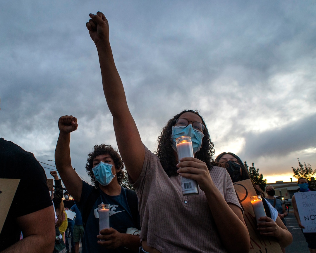(Rick Egan  |  The Salt Lake Tribune) Jayda Murphy holds a candles as she chants at the memorial for Bernardo Palacios-Carbajal during a demonstration on 900 South 300 West in Salt Lake City on Saturday, June 13, 2020.