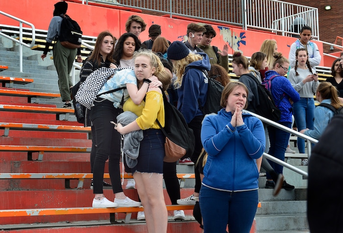 Scott Sommerdorf | The Salt Lake Tribune
James Grace Mackey, left, and Dahlia Dangerfield, Brighton High students hug as students who walked out of class head back to school after coming together to observe a moment of silence for each of the 17 students and staff killed at Marjory Stoneman Douglas High School, during their walkout at Brighton High School, Wednesday, March 14, 2018.
