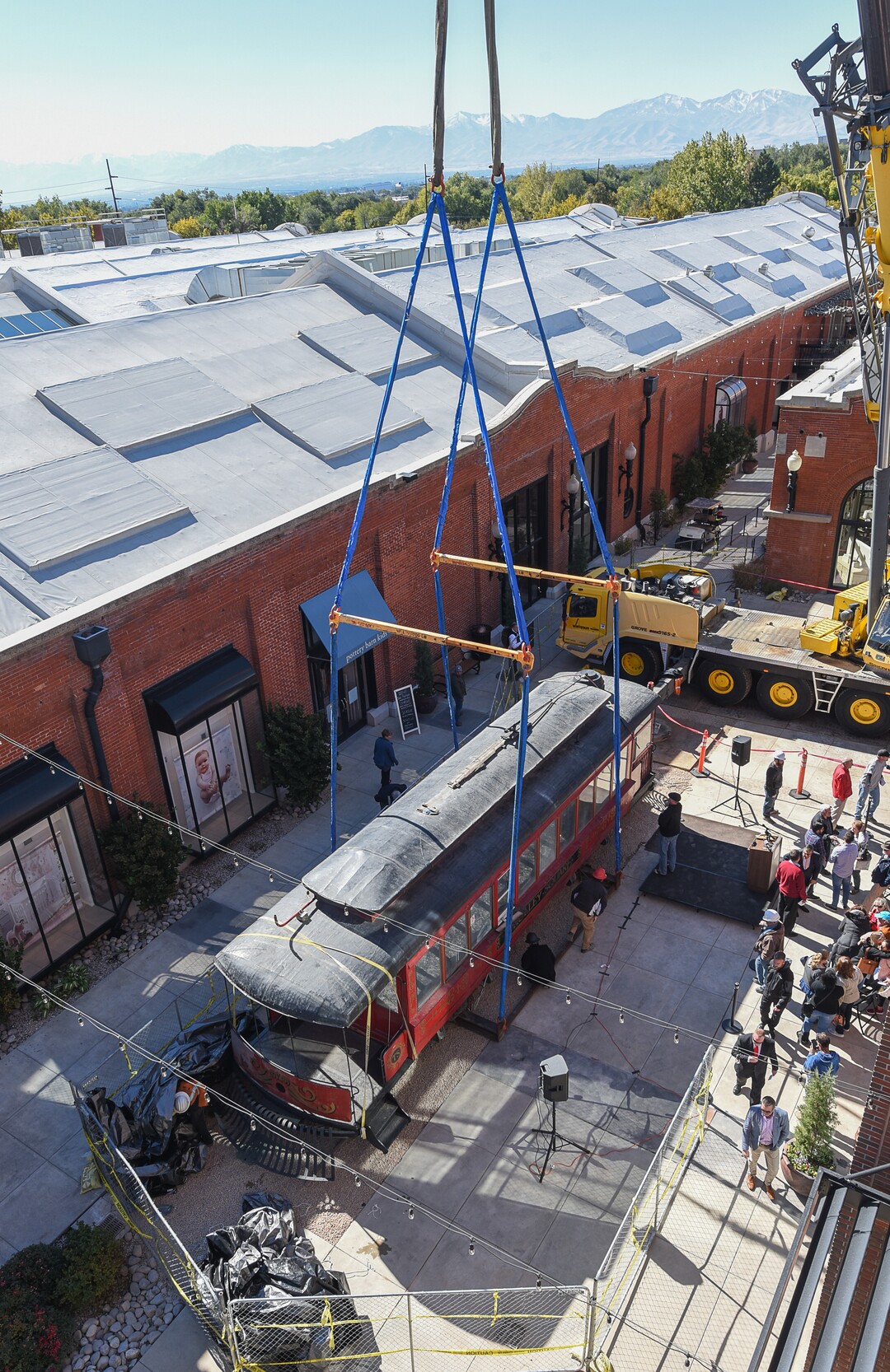 (Francisco Kjolseth  |  The Salt Lake Tribune)  The iconic trolley car, that has been sitting in storage for several years, is moved back into view at Trolley Square on Monday, Oct. 15, 2018 as people gather for the repositioning ceremony. The empty trolley car, last seen housing the Trolley Wing Company was moved into place on the north plaza by Pottery Barn.
