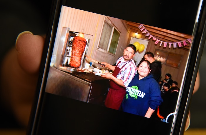 (Francisco Kjolseth  |  The Salt Lake Tribune)  Carolina Marquez shows off photos on her phone of her late husband Adrian De Los Santos Luna when they were first starting out selling tacos outside of their home in West Valley City. 